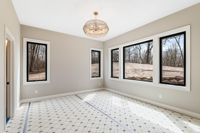4729 Linden Cove Ln, Savage, MN 55378 - spare room featuring an inviting chandelier, baseboards, and plenty of natural light