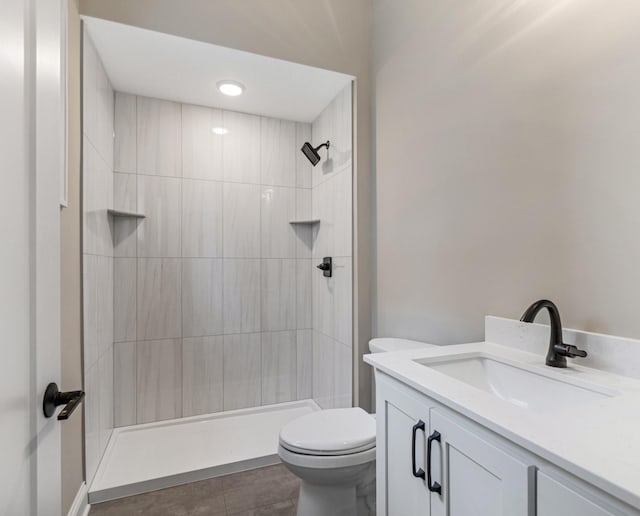 4729 Linden Cove Ln, Savage, MN 55378 - bathroom featuring vanity, tile patterned floors, a tile shower, and toilet