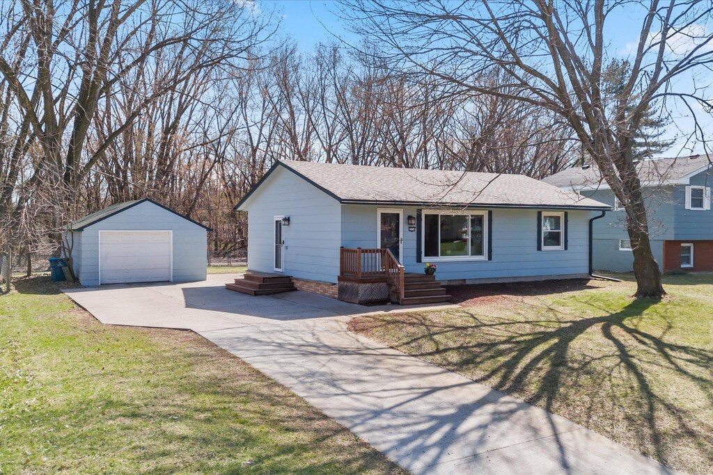 2234 Lois Dr, Mounds View, MN 55112 - single story home featuring roof with shingles, concrete driveway, a garage, an outdoor structure, and a front yard
