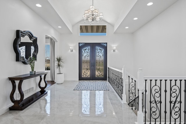 foyer entrance with arched walkways, baseboards, marble finish floor, an inviting chandelier, and recessed lighting