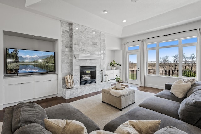 living room with recessed lighting, baseboards, wood finished floors, and a fireplace