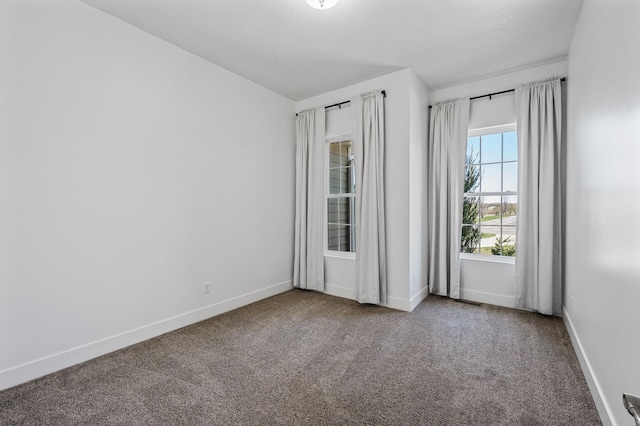 empty room with baseboards and carpet flooring