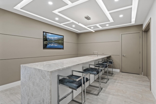 bar featuring baseboards, recessed lighting, and light wood-style flooring