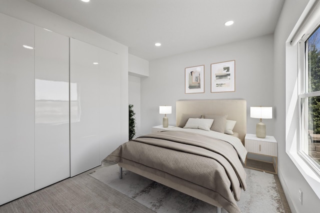 bedroom featuring recessed lighting and light carpet