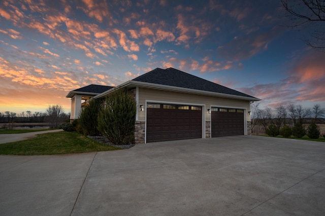 view of home's exterior with an attached garage, driveway, and stone siding