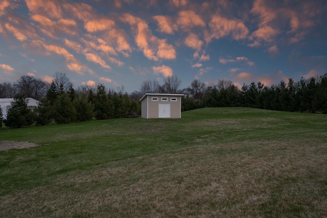 view of yard with an outbuilding and a shed