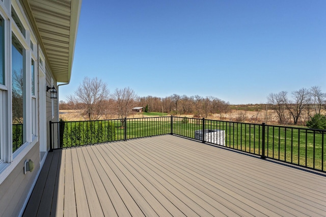 wooden terrace featuring a lawn