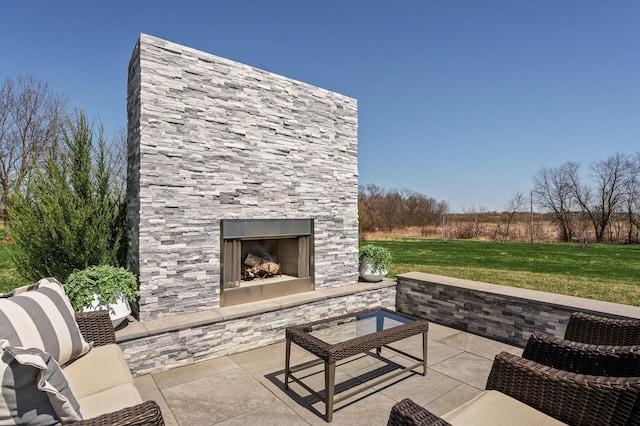 view of patio with an outdoor stone fireplace