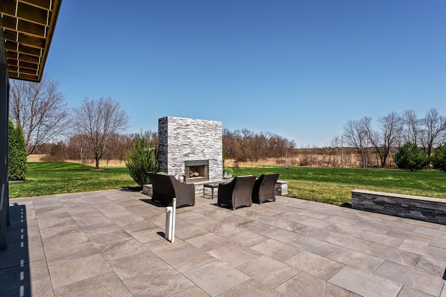 view of patio with an outdoor stone fireplace
