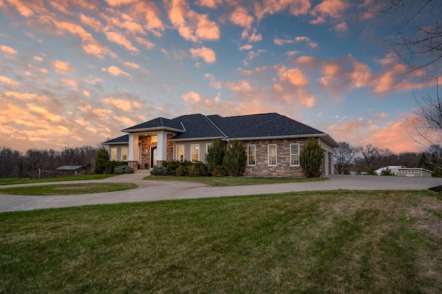 10906 Whitetail Rd, Rogers, MN 55374 - view of front of property with curved driveway, stone siding, a front lawn, and a garage