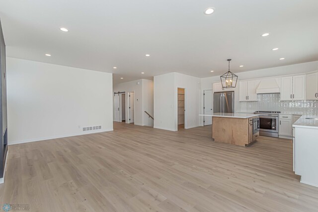 4288 Pine Pkwy S, Fargo, ND 58104 - kitchen with recessed lighting, open floor plan, a kitchen island, and stainless steel appliances