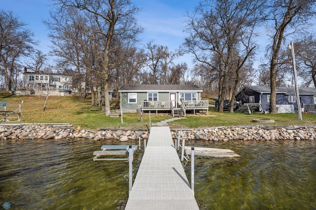 view of dock with a lawn and a deck with water view