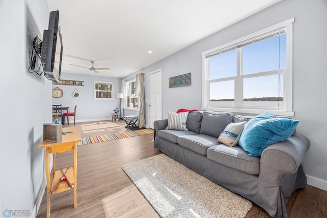 living room featuring baseboards, a ceiling fan, wood finished floors, and recessed lighting