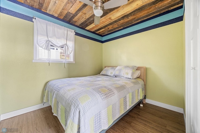 bedroom featuring wooden ceiling, baseboards, ceiling fan, and wood finished floors