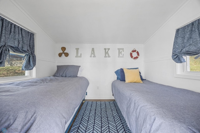 bedroom featuring ornamental molding and lofted ceiling