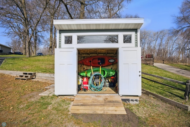 view of shed featuring fence