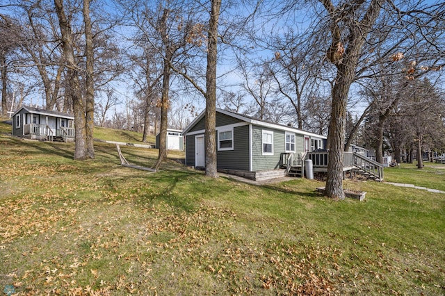 view of property exterior featuring a yard and a deck