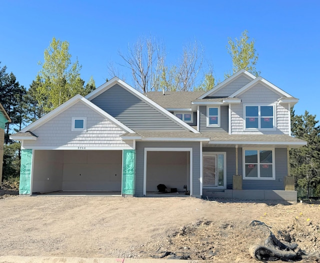 9706 Jasmine Ave NE, Hanover, MN 55341 - view of front of home featuring driveway, an attached garage, a porch, and roof with shingles
