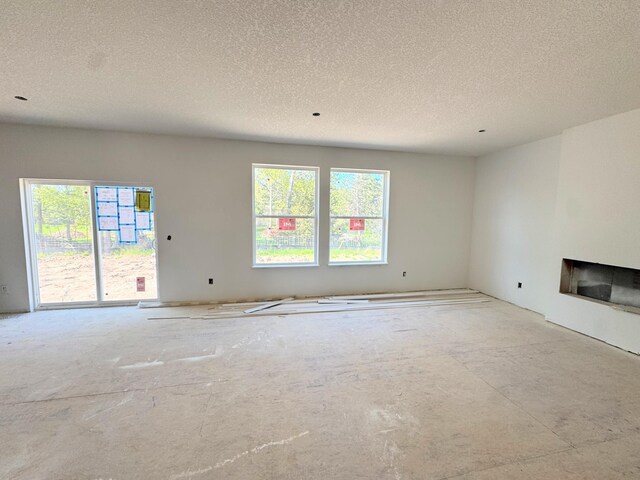 9706 Jasmine Ave NE, Hanover, MN 55341 - unfurnished living room with a fireplace and a textured ceiling