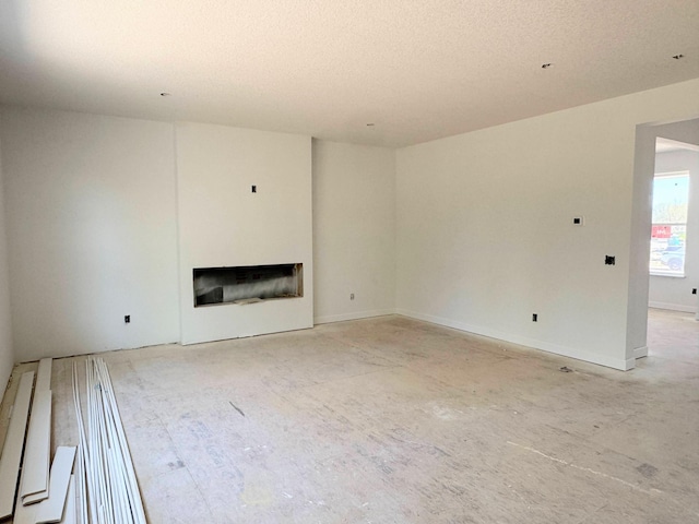 9706 Jasmine Ave NE, Hanover, MN 55341 - unfurnished living room featuring a fireplace and a textured ceiling