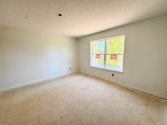 9706 Jasmine Ave NE, Hanover, MN 55341 - spare room with baseboards and a textured ceiling