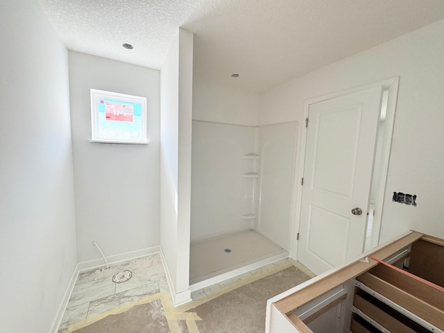 9706 Jasmine Ave NE, Hanover, MN 55341 - bathroom with a stall shower, baseboards, and a textured ceiling