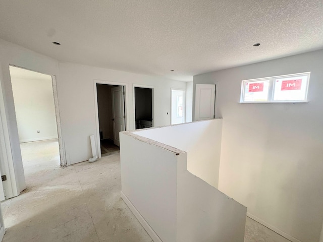 9706 Jasmine Ave NE, Hanover, MN 55341 - hallway with an upstairs landing, a textured ceiling, and baseboards