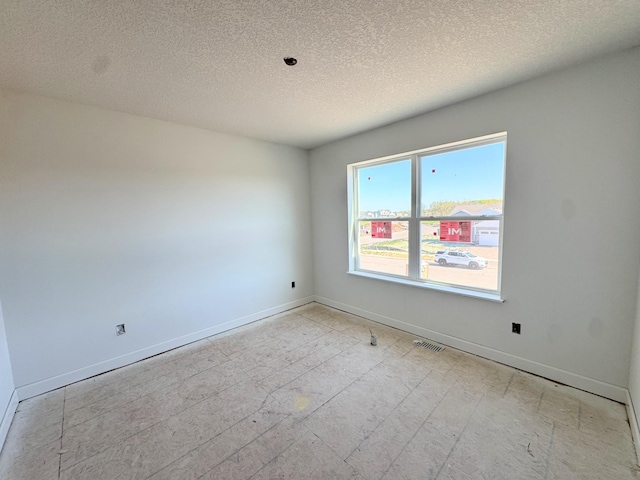 9706 Jasmine Ave NE, Hanover, MN 55341 - unfurnished room with baseboards and a textured ceiling