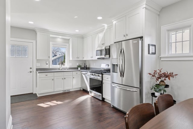 1744 Jefferson Ave, Saint Paul, MN 55105 - kitchen with stainless steel appliances, white cabinetry, dark wood-type flooring, and recessed lighting