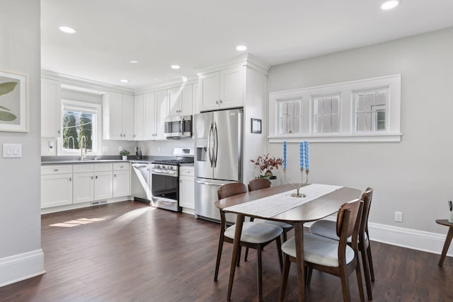 1744 Jefferson Ave, Saint Paul, MN 55105 - kitchen with appliances with stainless steel finishes, baseboards, dark wood-style floors, white cabinetry, and recessed lighting