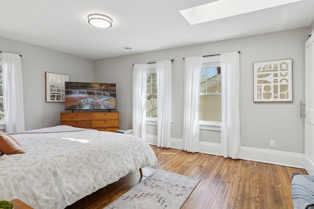 1744 Jefferson Ave, Saint Paul, MN 55105 - bedroom featuring a skylight, hardwood / wood-style flooring, and baseboards