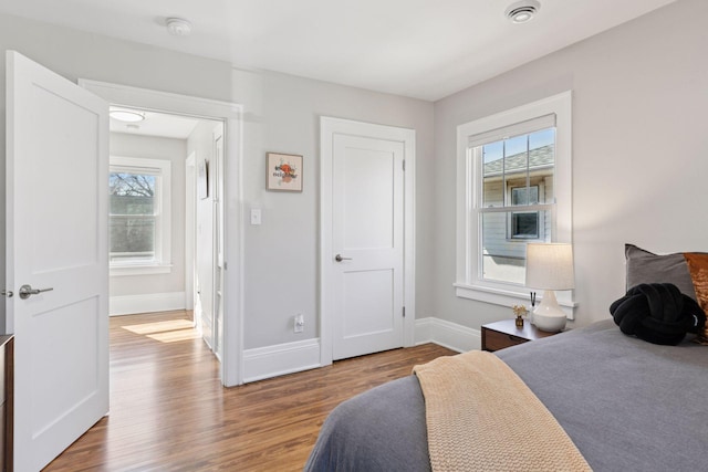 1744 Jefferson Ave, Saint Paul, MN 55105 - bedroom featuring wood finished floors, baseboards, and multiple windows