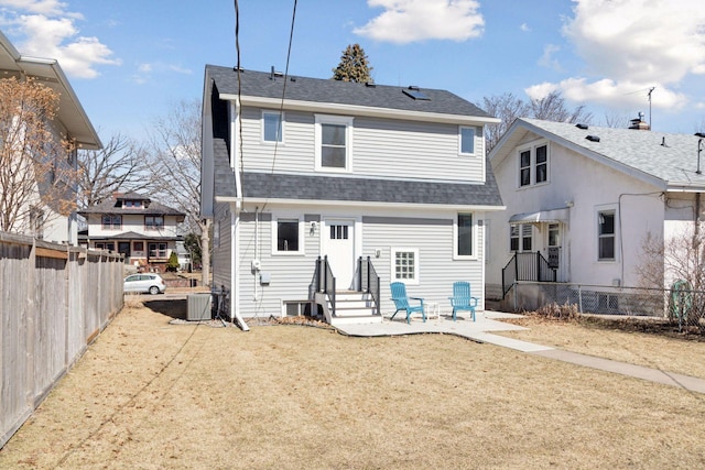 1744 Jefferson Ave, Saint Paul, MN 55105 - rear view of house with entry steps, a fenced backyard, central air condition unit, and a shingled roof