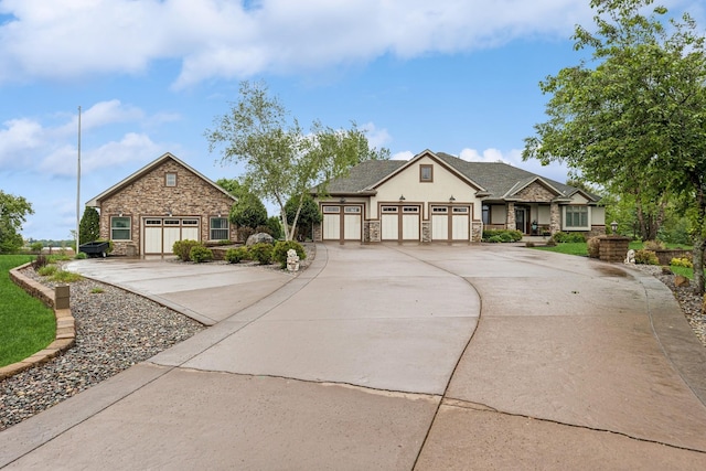 3041 209th Ln NW, Oak Grove, MN 55011 - view of front facade with stone siding, driveway, an attached garage, and stucco siding