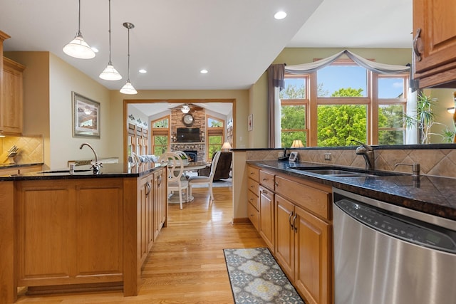 3041 209th Ln NW, Oak Grove, MN 55011 - kitchen with dishwasher, light wood-type flooring, tasteful backsplash, a fireplace, and a sink