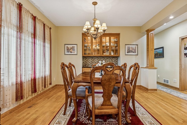 3041 209th Ln NW, Oak Grove, MN 55011 - dining room with light wood-style flooring, a chandelier, ornate columns, baseboards, and recessed lighting