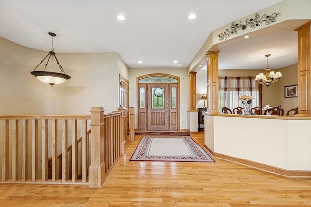 3041 209th Ln NW, Oak Grove, MN 55011 - entryway featuring light wood finished floors, a chandelier, recessed lighting, and decorative columns