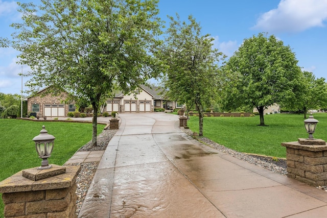 3041 209th Ln NW, Oak Grove, MN 55011 - view of front of property with concrete driveway, a front lawn, and a garage