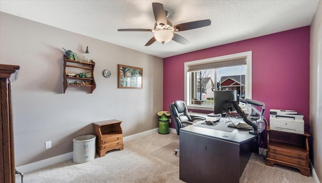 carpeted office featuring baseboards, a textured ceiling, and ceiling fan