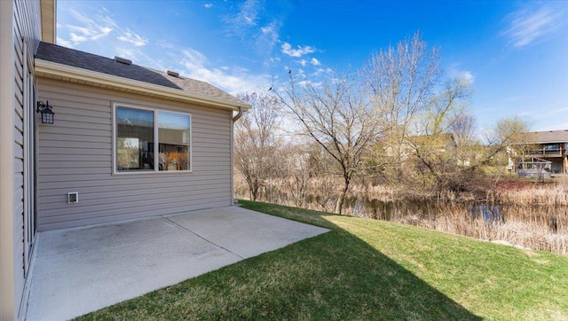 view of yard with a patio and a water view