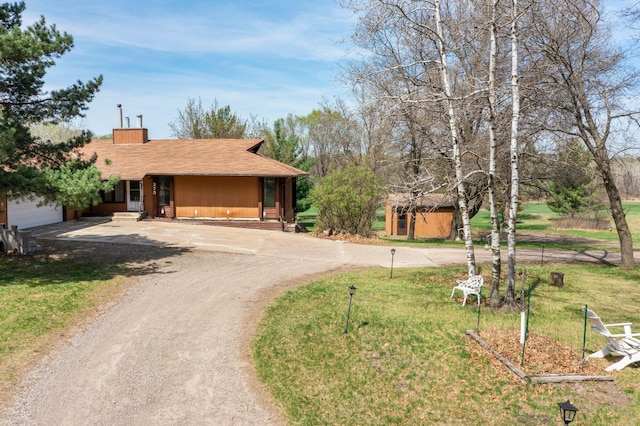 ranch-style house featuring an attached garage, a chimney, roof with shingles, and dirt driveway
