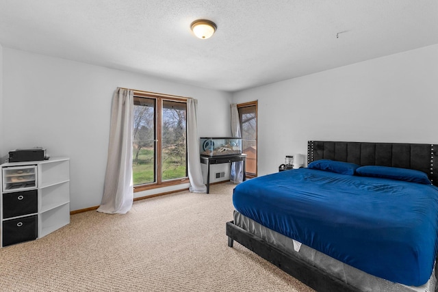 carpeted bedroom featuring baseboards and a textured ceiling