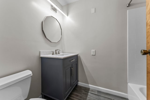 full bath with vanity, wood finished floors, toilet, baseboards, and  shower combination