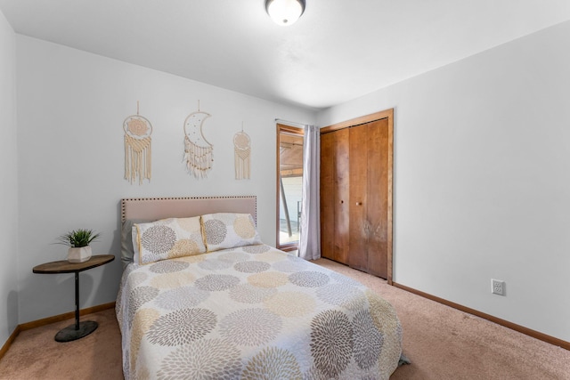 carpeted bedroom with baseboards and a closet