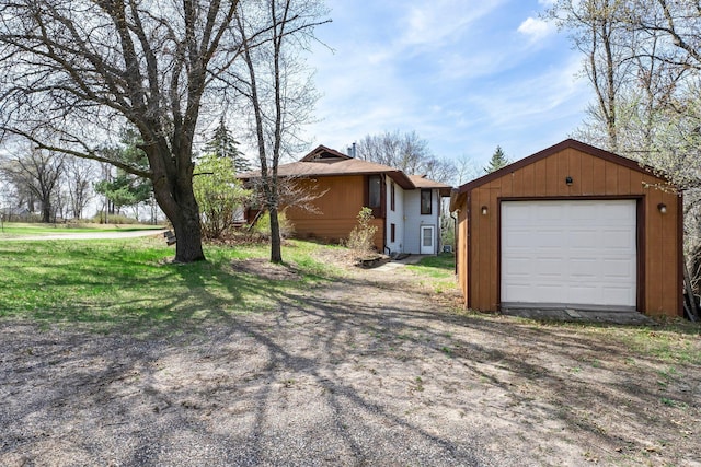 view of front of home with an outdoor structure and a detached garage