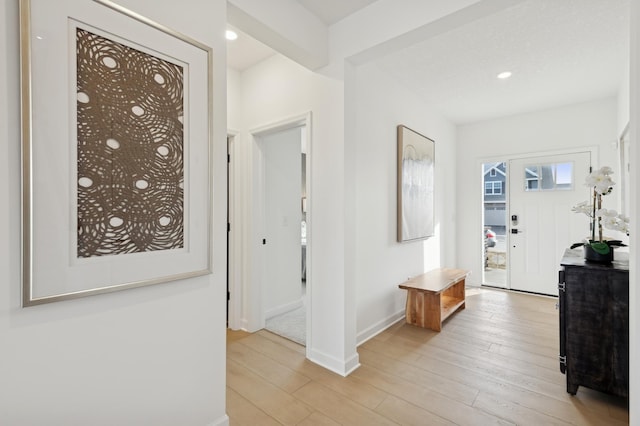 foyer featuring recessed lighting, baseboards, and light wood finished floors
