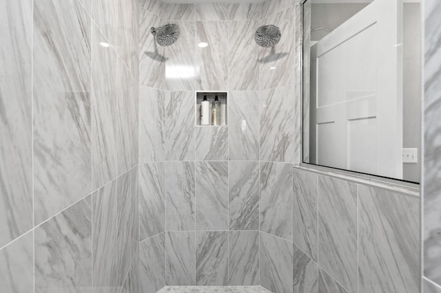 interior space with tiled shower