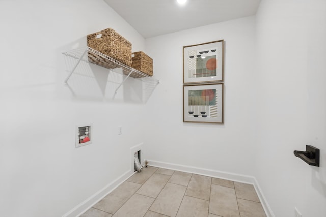 clothes washing area featuring light tile patterned floors, washer hookup, baseboards, and laundry area