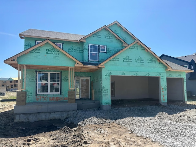 property under construction featuring an attached garage and covered porch