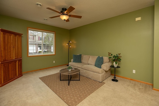 living area with a ceiling fan, carpet flooring, and baseboards